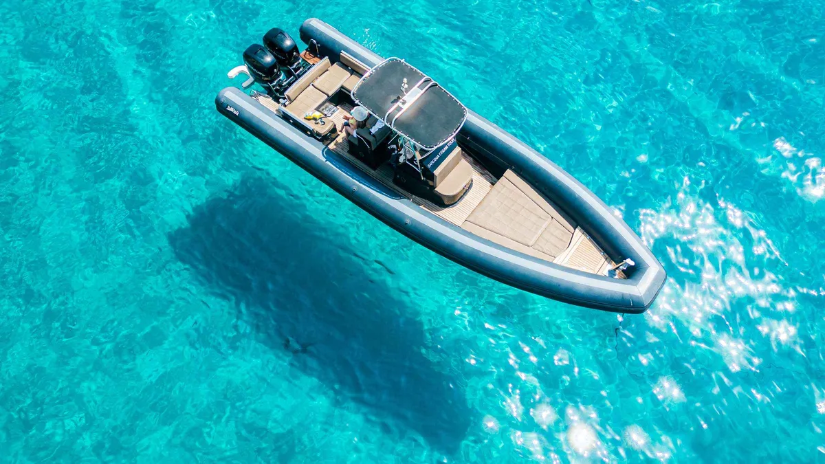 Zodiac rigid inflatable speeding along the Cagliari coastline on a budget boat tour in the Gulf of Cagliari, Sardinia